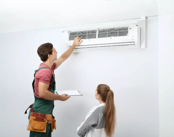 A Durham HVAC technician explaining an AC filter inspection to a homeowner during a professional consultation.